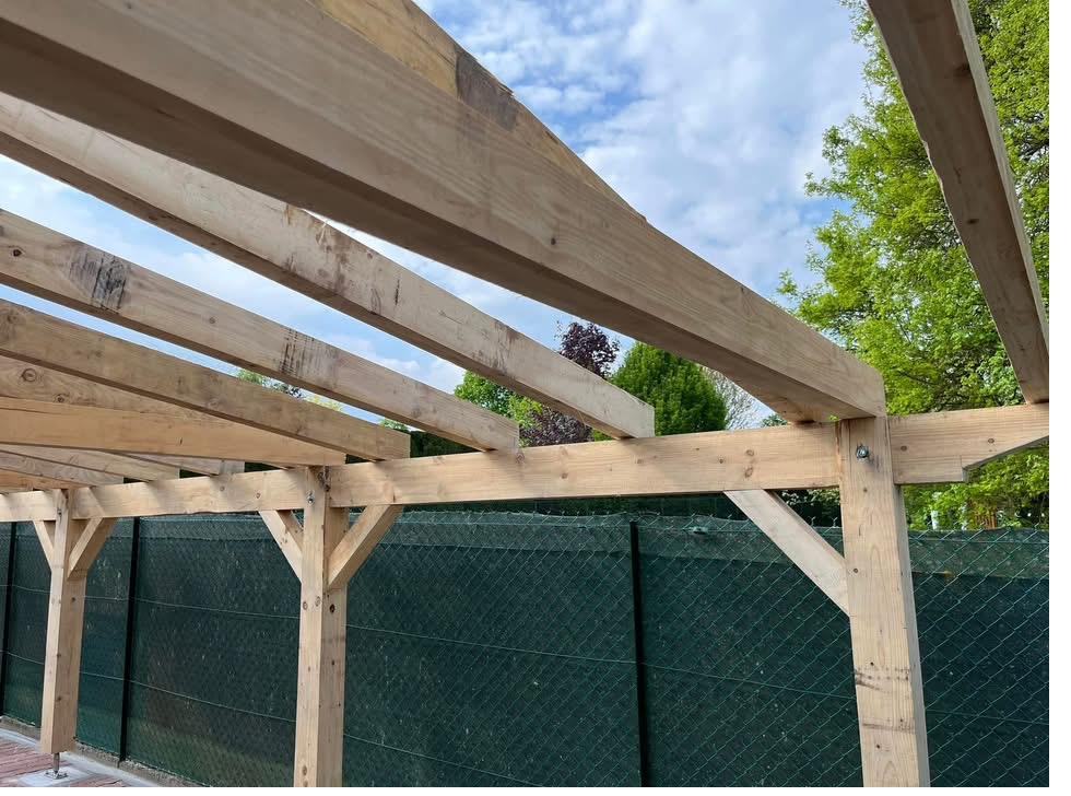 Abri de terrasse et carport en bois massif construits par un charpentier à Golbey